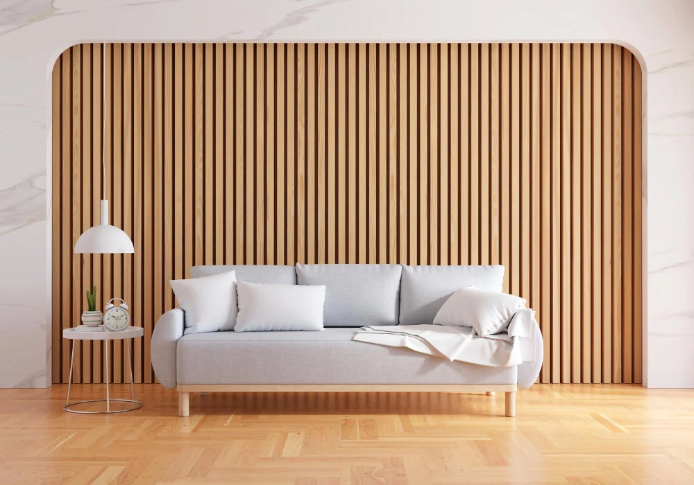 Light oak wood feature wall behind a gray sofa in a bright living room with white accents.