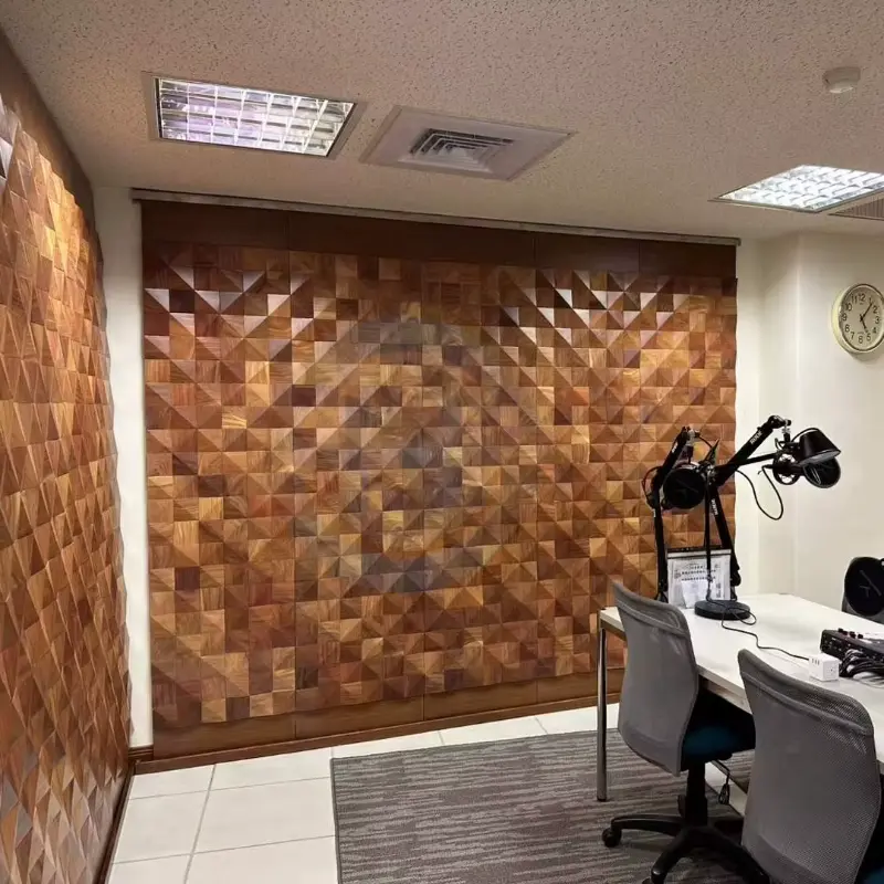 Walnut triangle mosaic panelling covering an office wall behind desks and chairs