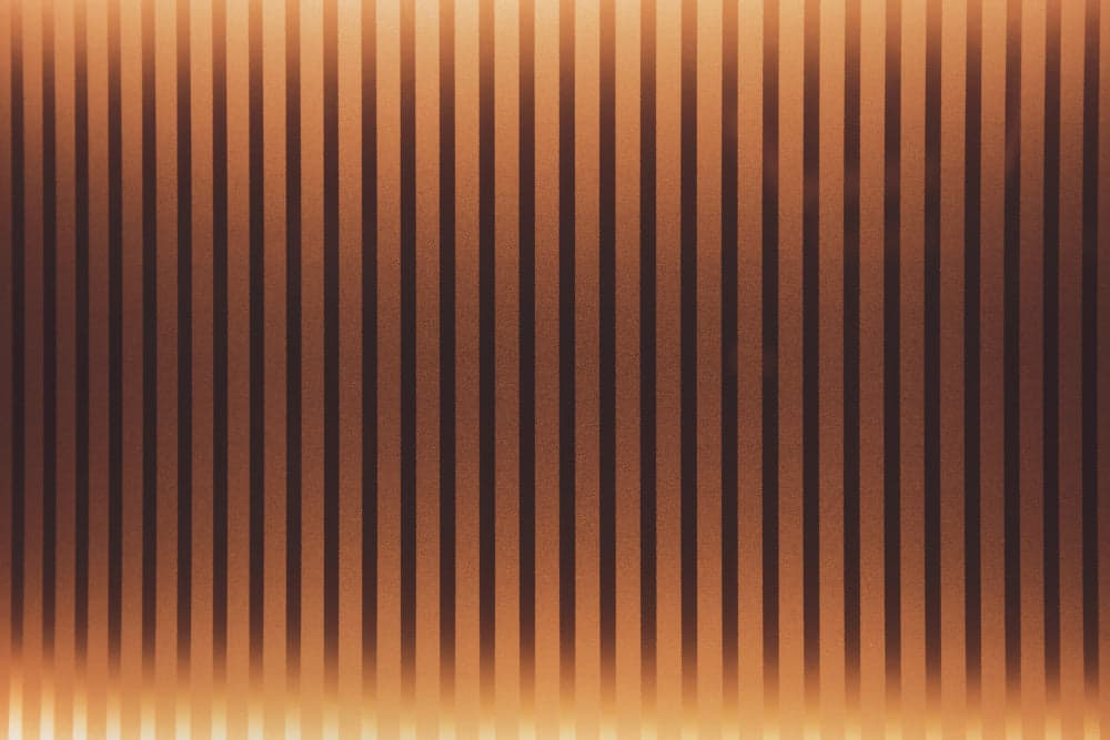 Americana interior design with warm amber lighting, stripe wall panels, and natural textures for an inviting home.