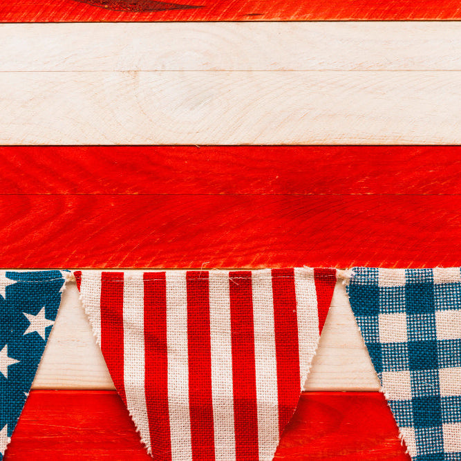 Americana theme decor with framed vintage flag, patchwork quilts, and subtle star motifs for heritage-inspired interiors.