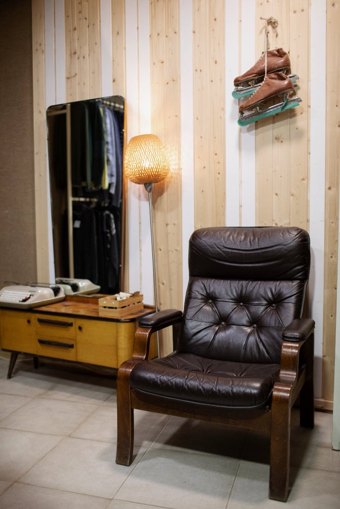 Classic Americana interior design with oak wall panels, reclaimed wood, and aged leather furniture in rustic tones.